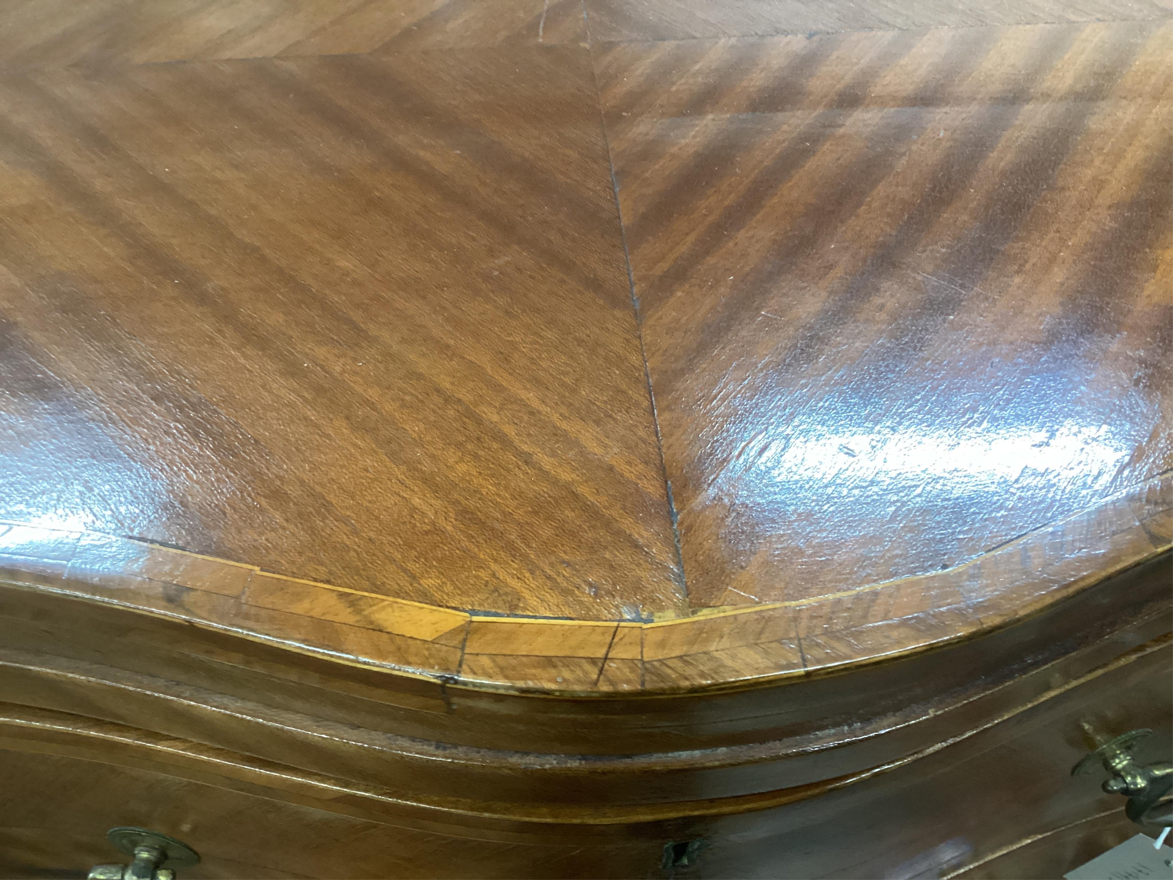 A small reproduction mahogany serpentine chest, with slide, width 60cm, depth 39cm, height 71cm. Condition - fair